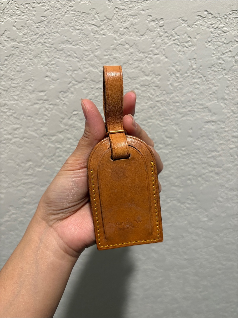 Louis Vuitton leather luggage tag.